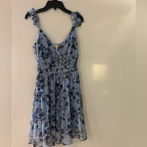 Blue floral dress. V-neck. Adjustable straps. Never worn but has no tags